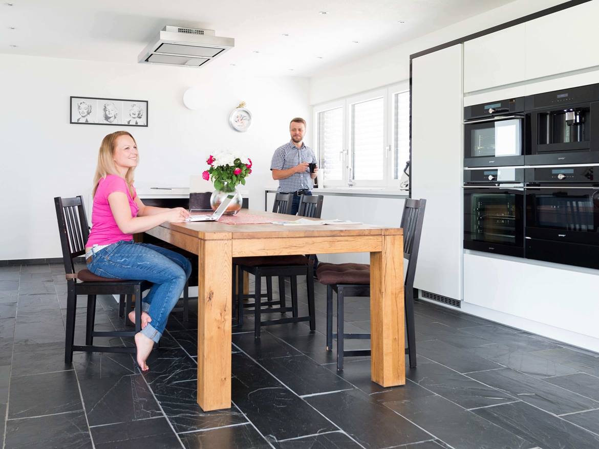 Esszimmer mit Holztisch und moderner Einrichtung, Schieferfliesen als Bodenbelag