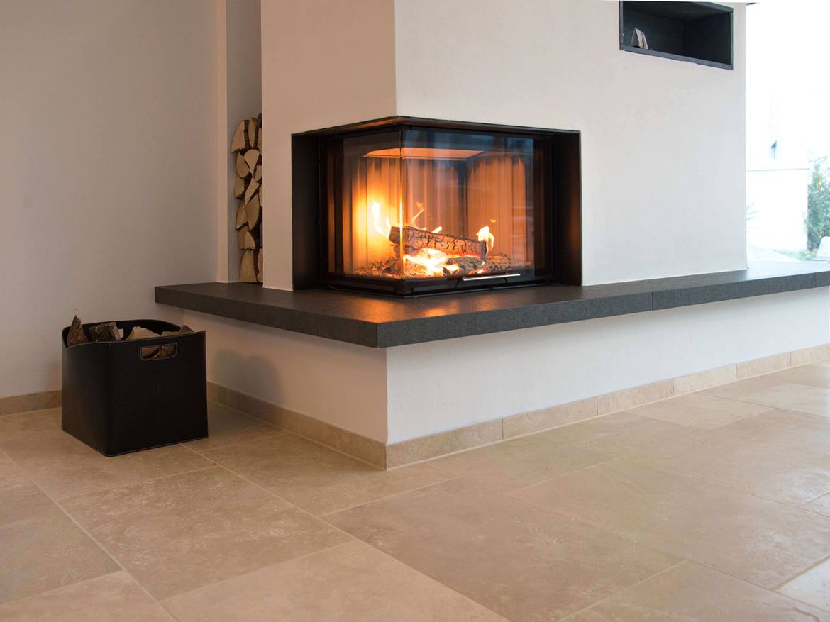 Moderner weisser Kamin mit beige-braunem Travertinboden